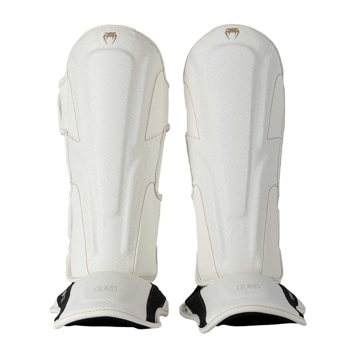 Protège-tibias Venum Impact Evo Scales ivoire en cuir Skintex pour boxe thaï, kickboxing et MMA, mousse multi-densités et maintien velcro sécurisé.