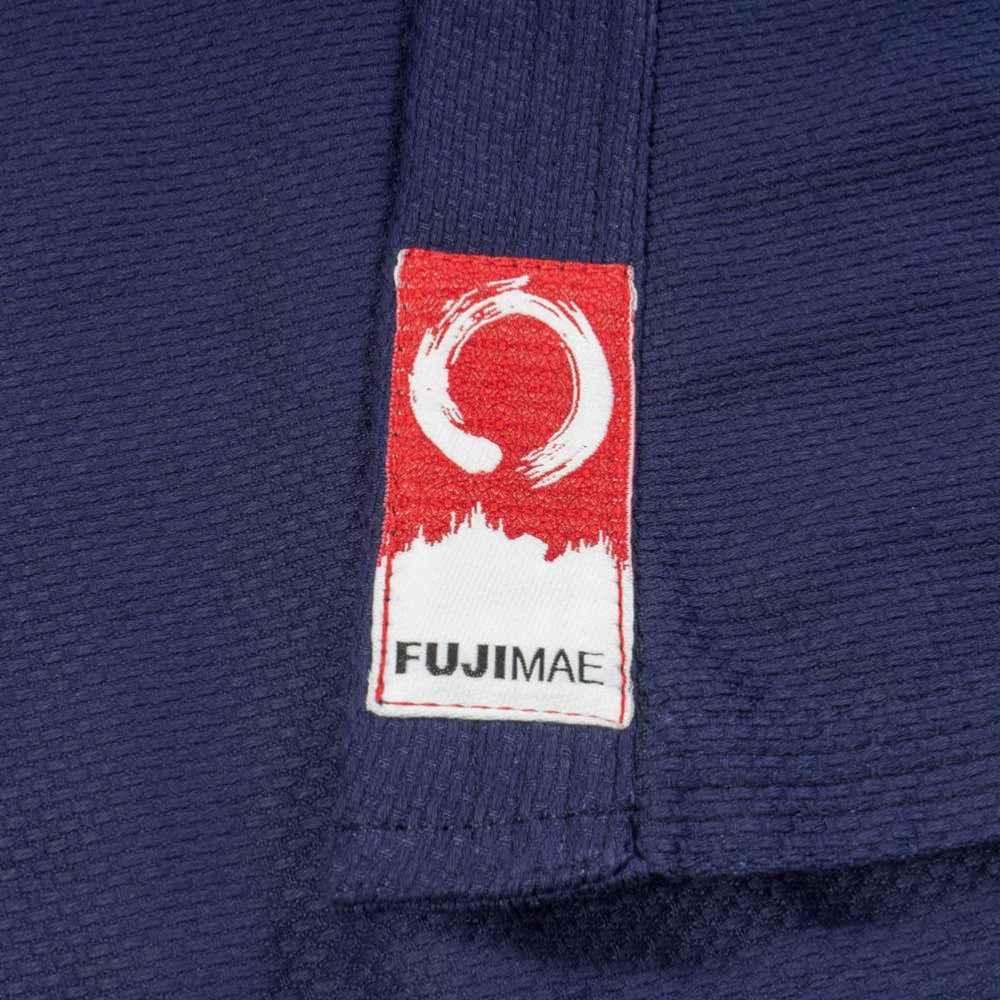Close-up of blue FUJIMAE Kendo jacket fabric with red and white brand label