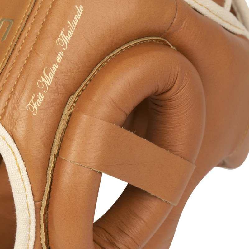 Close-up of brown leather Casque de Boxe Elion boxing headgear handmade in Thailand with padded protection and reinforced stitching