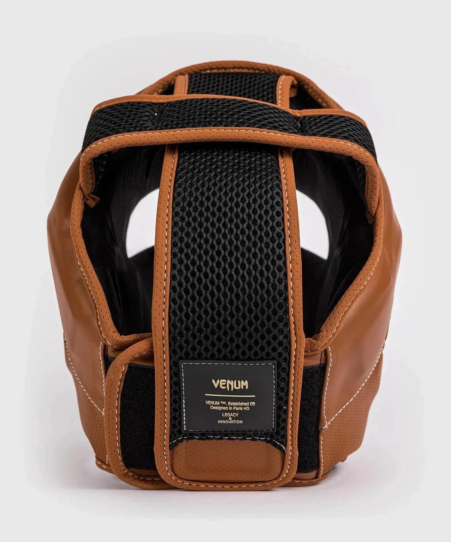 Vintage brown and black Venum Impact Evo boxing headgear with breathable lining and adjustable Velcro strap for premium protection and style