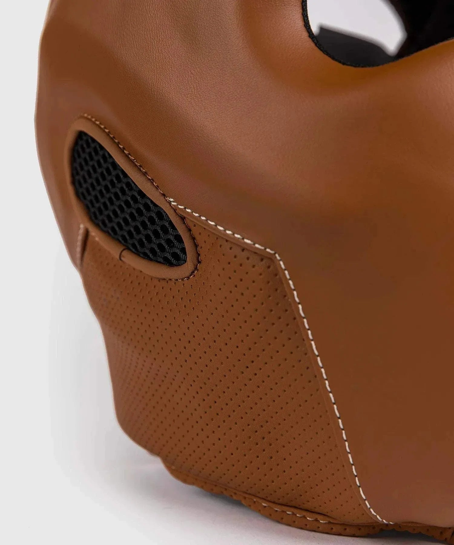 Close-up of brown Venum Impact Evo Havana boxing headgear with perforated Skintex leather and ventilation mesh detail