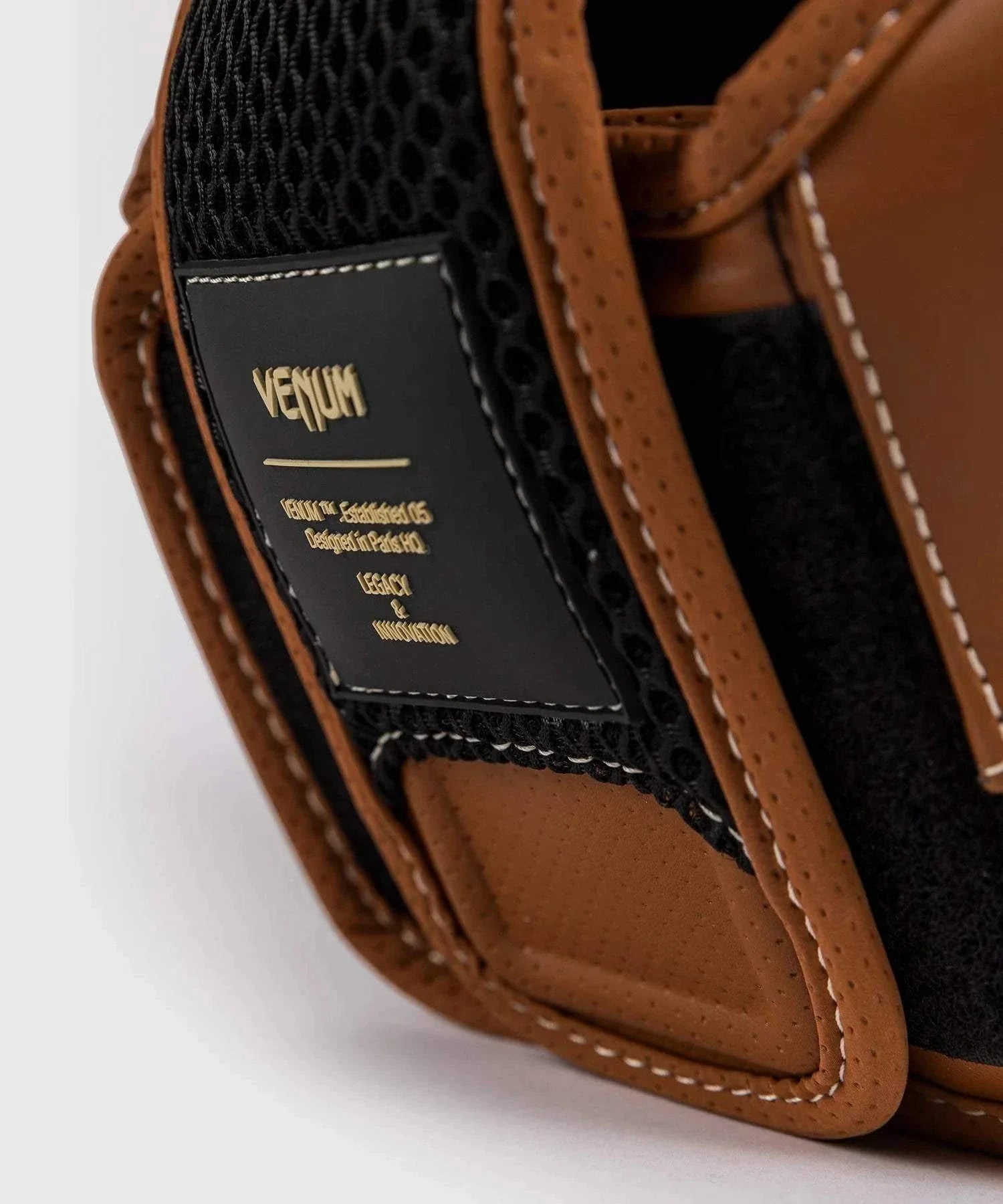 Close-up of brown and black Venum Impact Evo Havana boxing headgear with Skintex leather finish and breathable mesh panel
