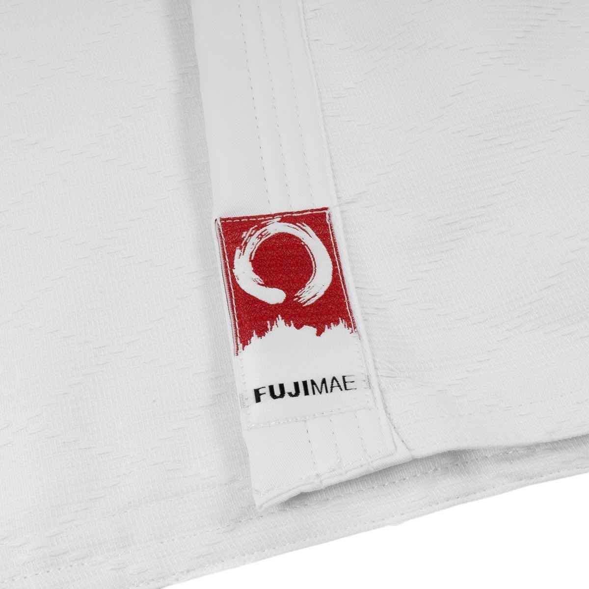 Close-up of white Fujimae Keikogi Aïkido training jacket with red and white Fujimae logo patch