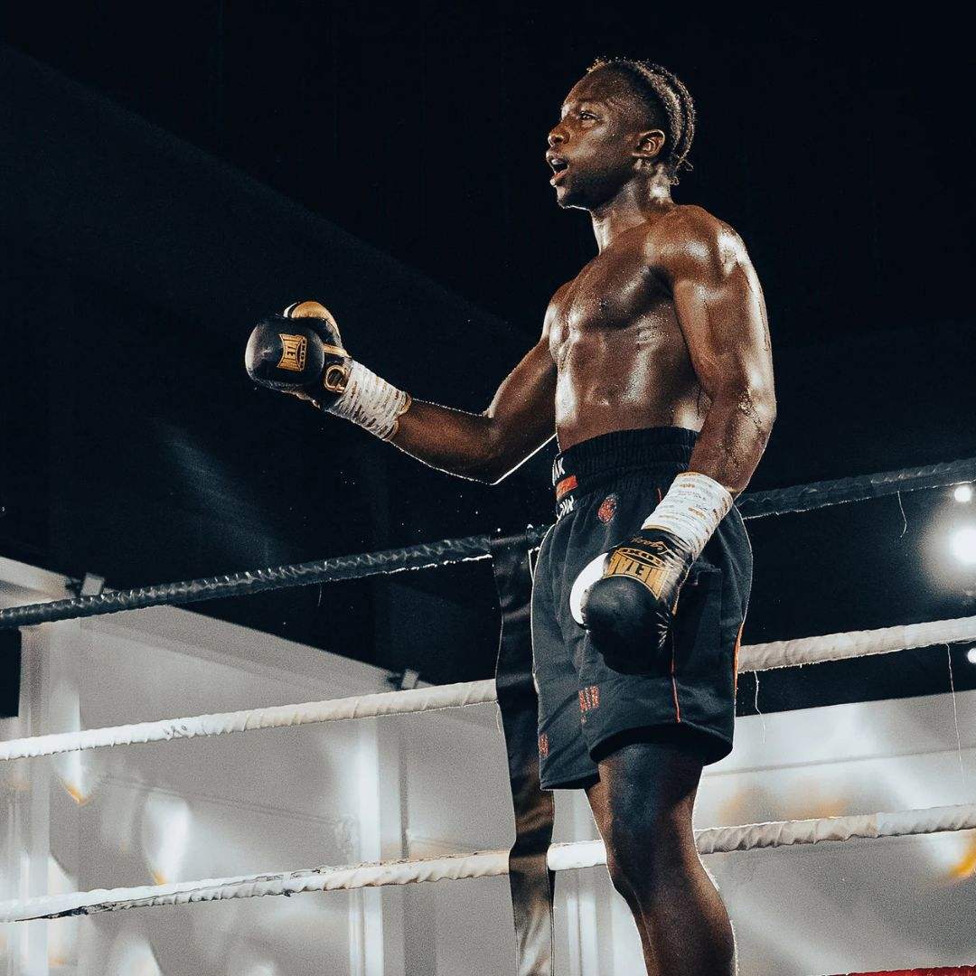 Boxer wearing black Gants de Boxe Metal Boxe Legacy foam lace-up gloves in the ring