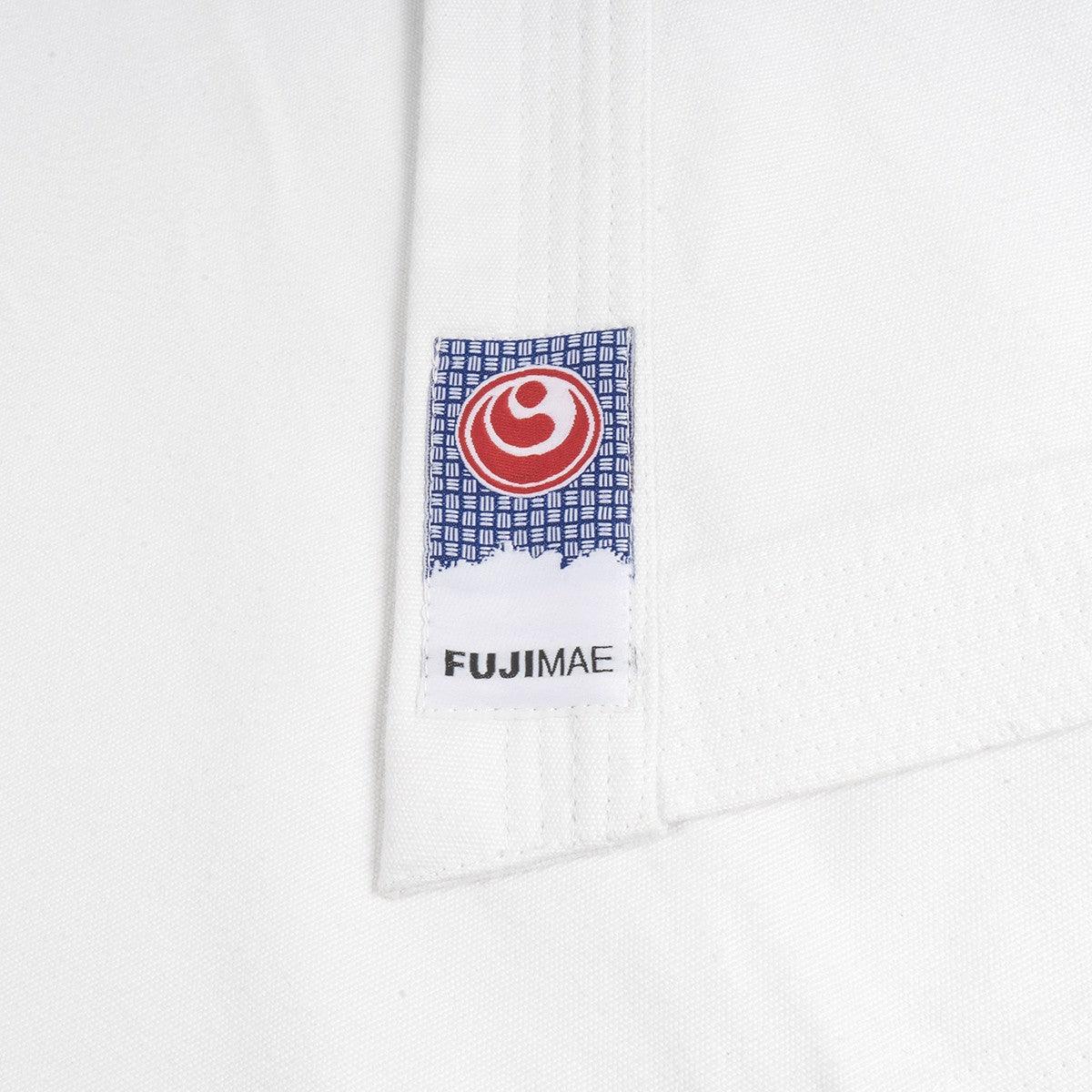 Close-up of the FUJIMAE label on the white Shinkyokushin Yantsu Karate Gi fabric