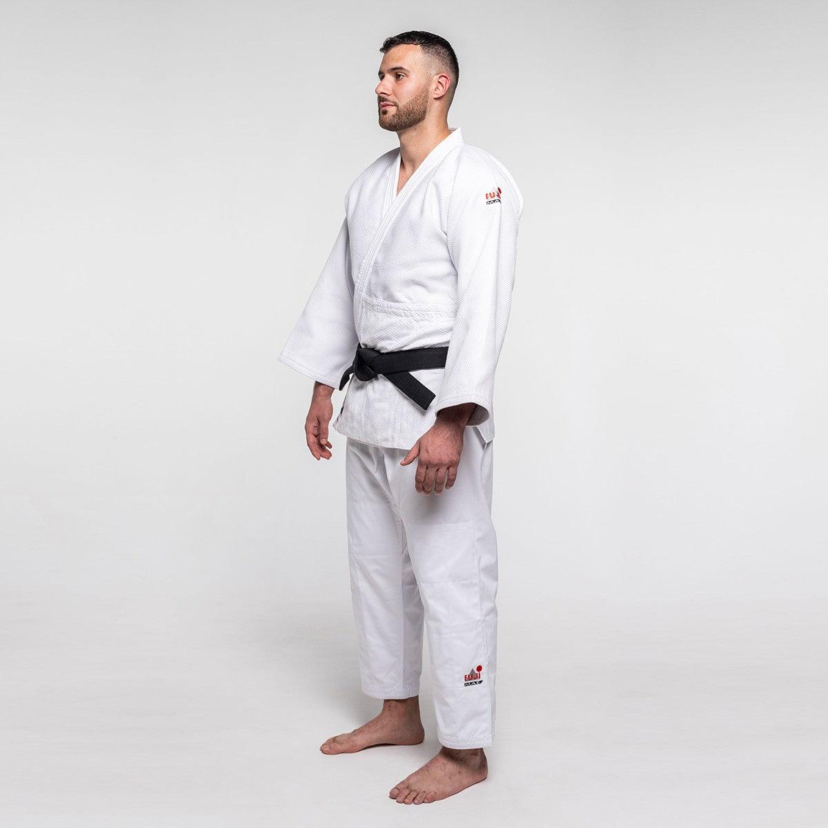 Man wearing white Judo Gi ProWear 2 with black belt standing on plain background