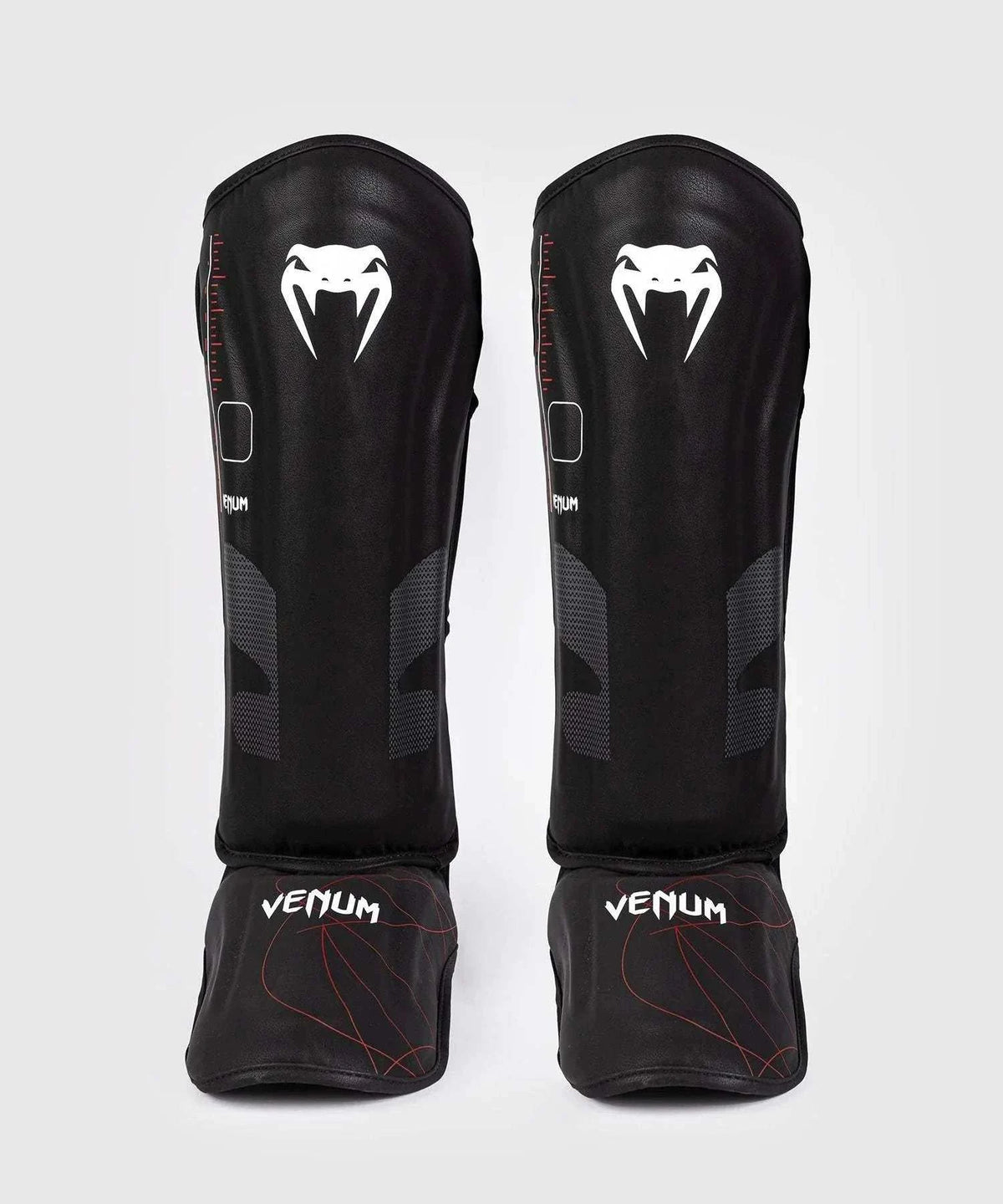 Black and red Venum Tactical XT shin and foot guards with multi-density foam and velcro straps for shock absorption and secure fit.