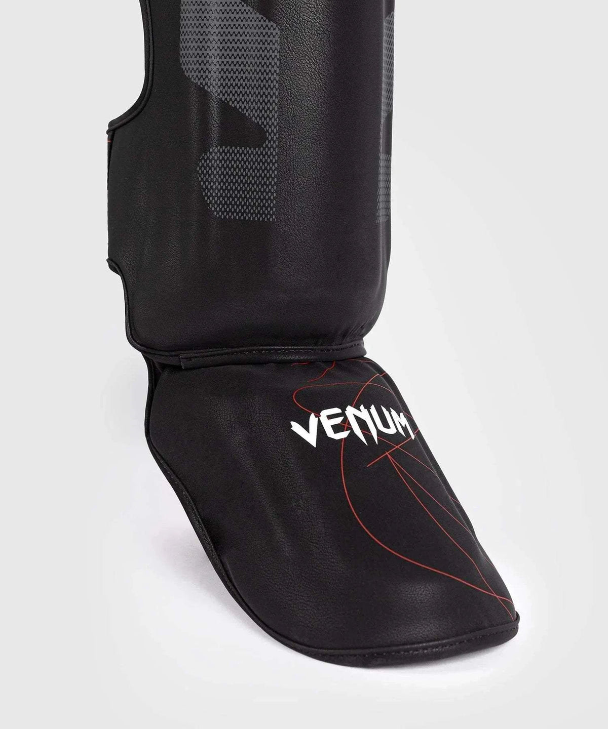 Black and red Venum Tactical XT shin and foot guards with multi-density foam and Velcro straps for MMA and boxing protection