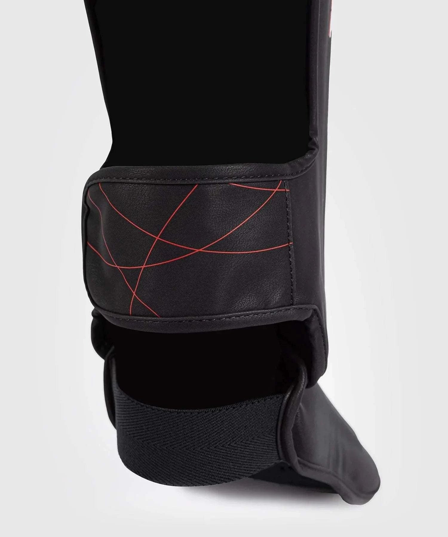 Black and red Venum Tactical XT shin and foot guards with multi-density foam and Velcro straps for martial arts protection