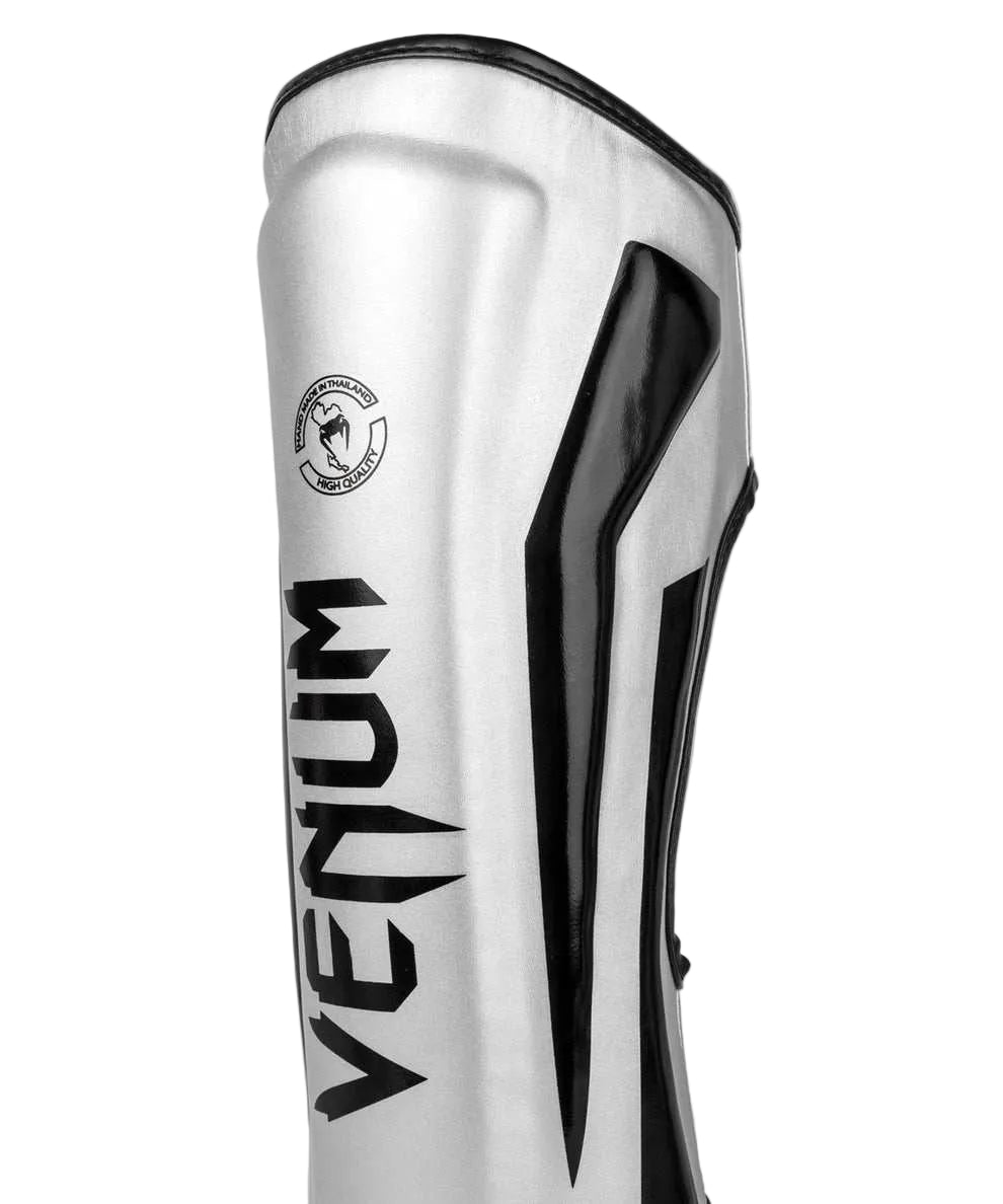 Protège-tibias Venum Elite argent noir haute protection combats pieds-poings ergonomique et résistant