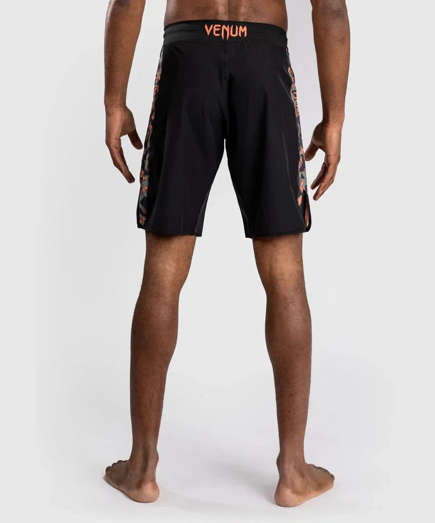 Back view of a person wearing black Fightshort Venum Jungle Ops with kaki camo side panels designed for MMA and grappling training.