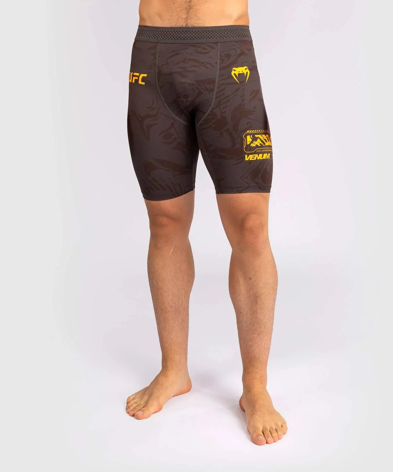 UFC Fusion par Venum black compression shorts with yellow logos for MMA training and fight preparation