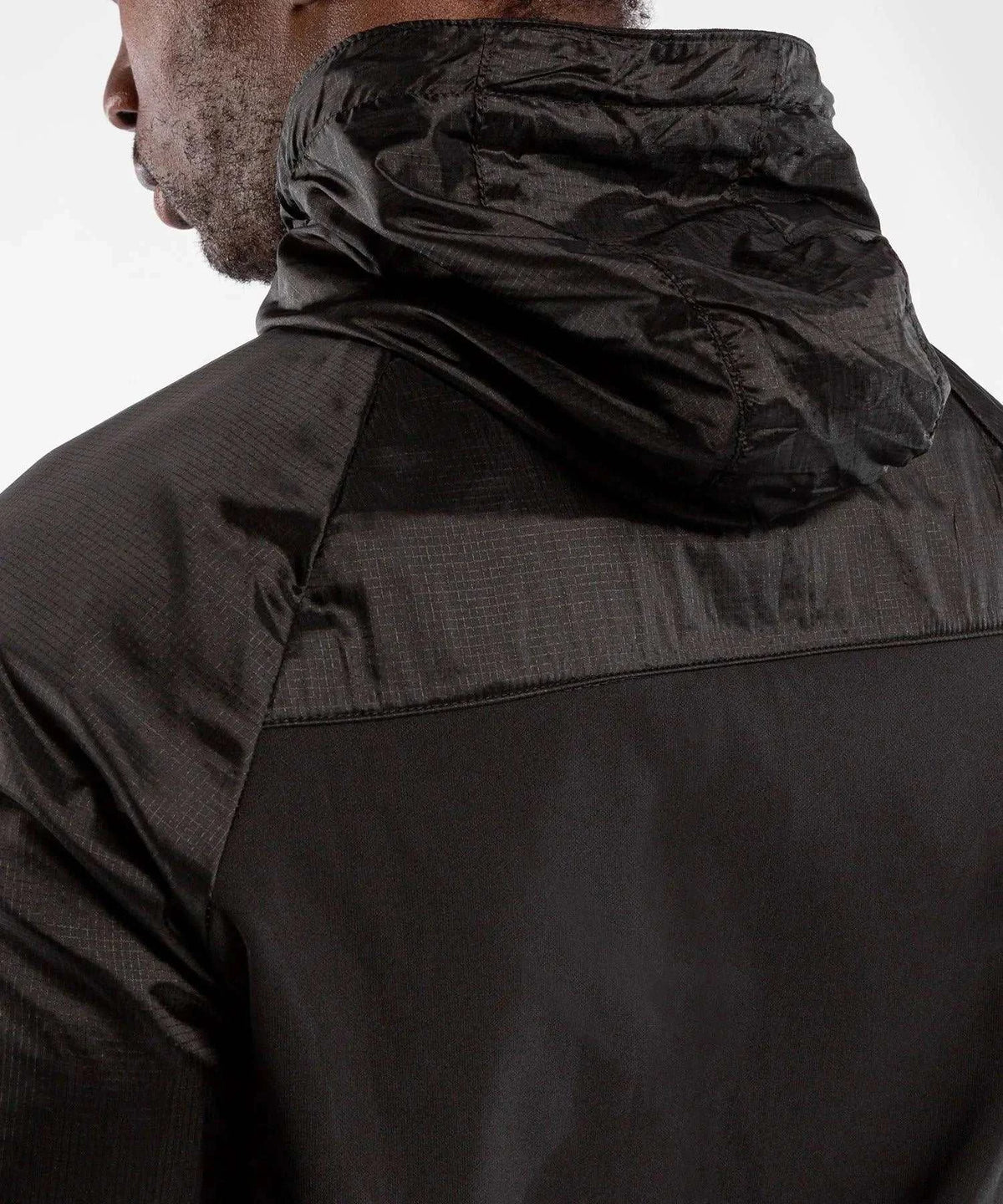 Rear close-up of black Venum Laser XT hooded sweatshirt with textured waterproof fabric and adjustable hood
