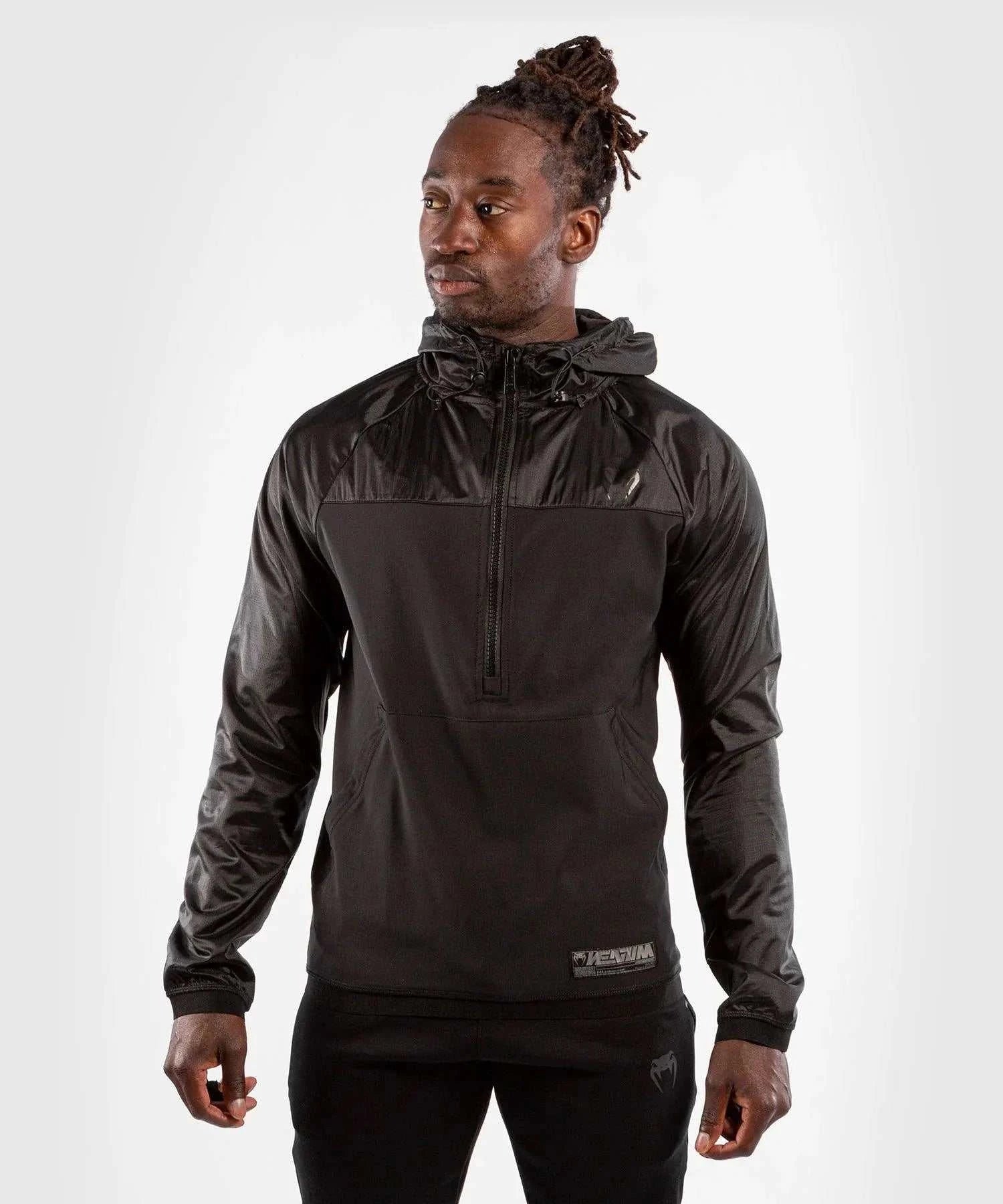 Black Venum Laser XT hoodie with half-zip and kangaroo pocket worn by male model