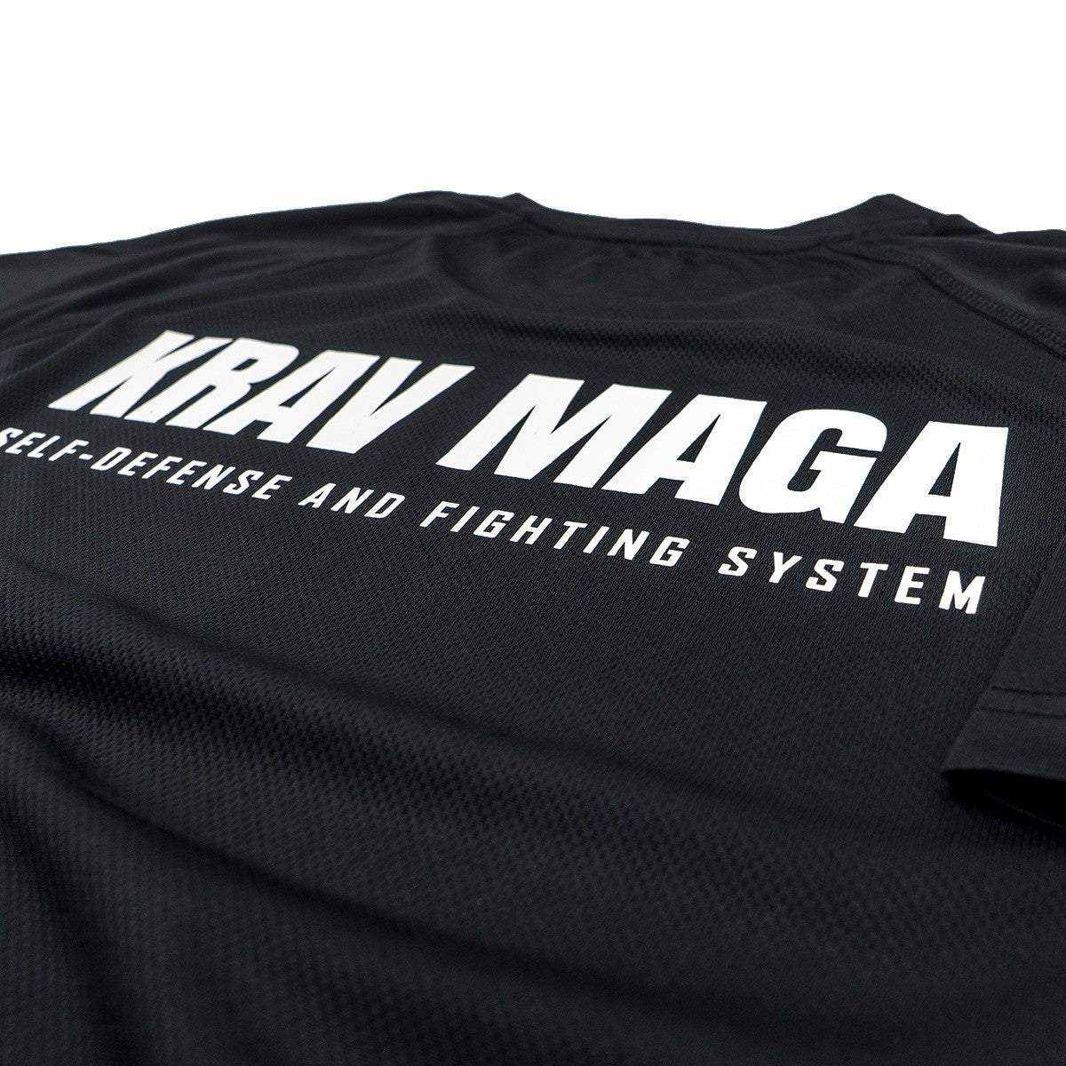 Black T-Shirt Dry Tec with bold white Krav Maga self-defense and fighting system text, lightweight breathable polyester fabric.