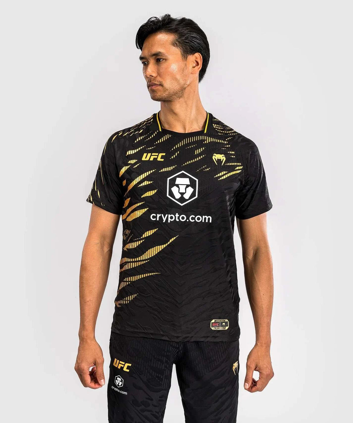 Men's UFC Fusion par Venum black and gold dry-tech performance T-shirt with short sleeves and sublimated graphics