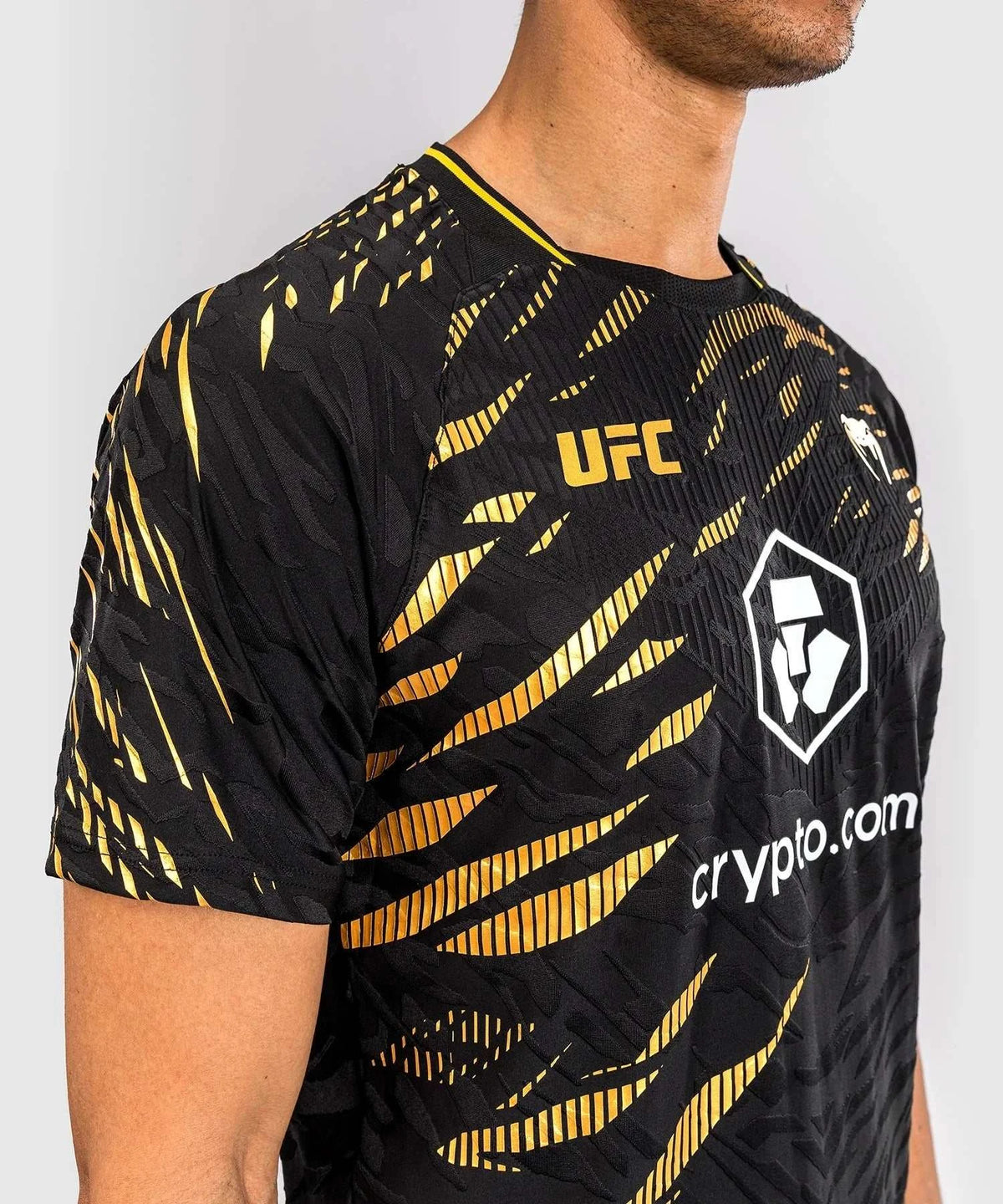 Black and gold UFC Fusion par Venum Dry-Tech performance men's T-shirt with short sleeves and breathable fabric design