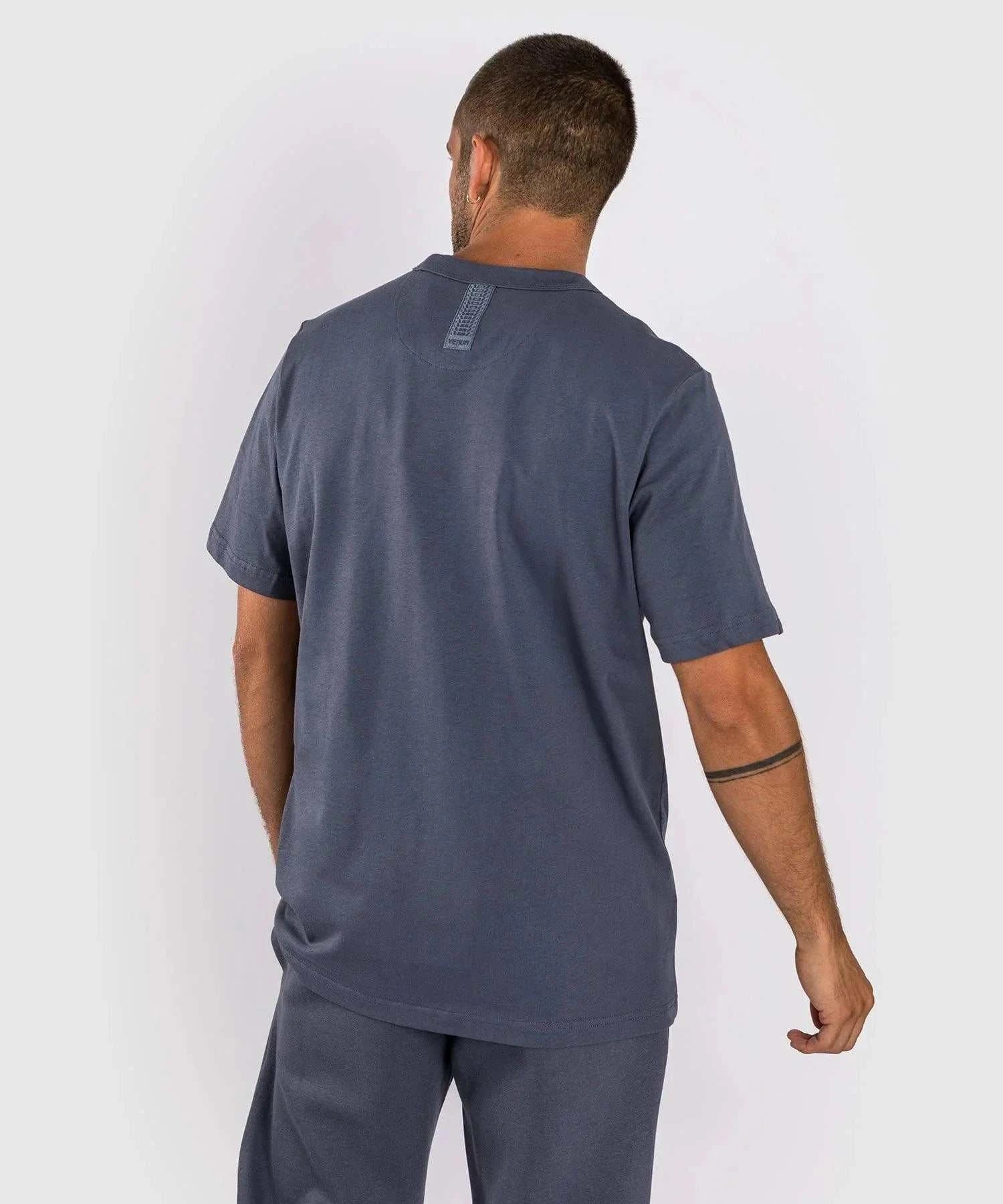 back view of man wearing navy blue Venum Silent Power t-shirt with short sleeves and round neck