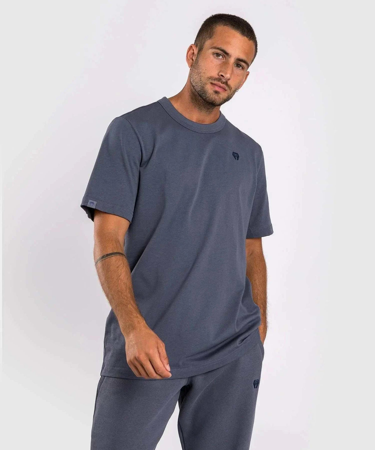 Man wearing navy blue Venum Silent Power t-shirt with round neck and short sleeves, featuring a subtle tonal logo on the chest.