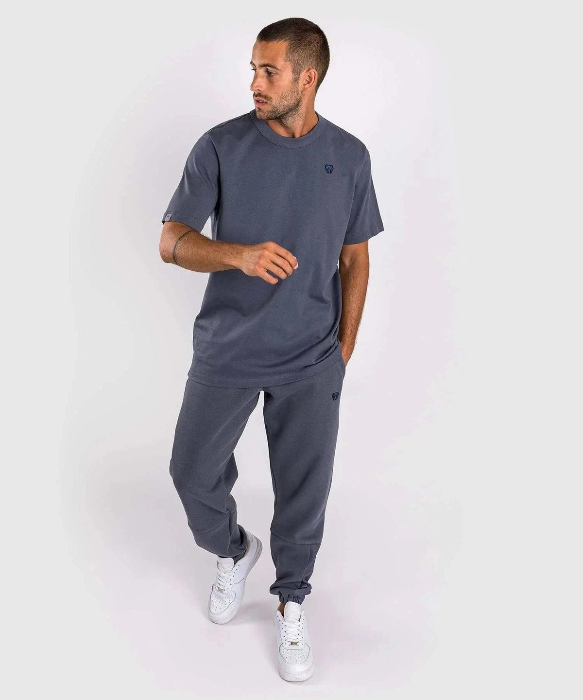Man wearing blue Venum Silent Power t-shirt and matching joggers with round neck and short sleeves.