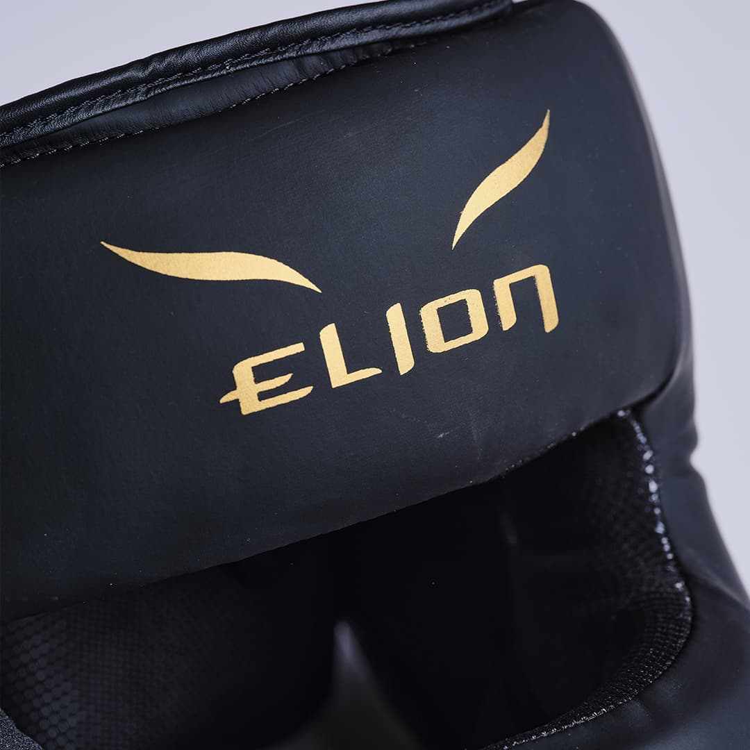 Casque à barre Elion Extravagant noir et or pour protection de sparring avec mousse épaisse et réglage par lacets