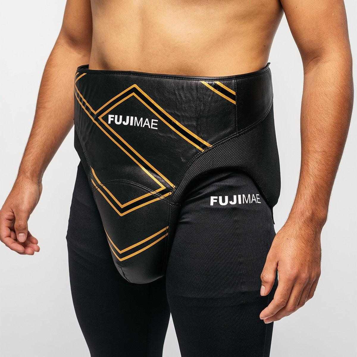 Black FUJIMAE professional boxing sparring groin protector worn by male model, made with durable synthetic leather and adjustable Velcro straps for secure fit