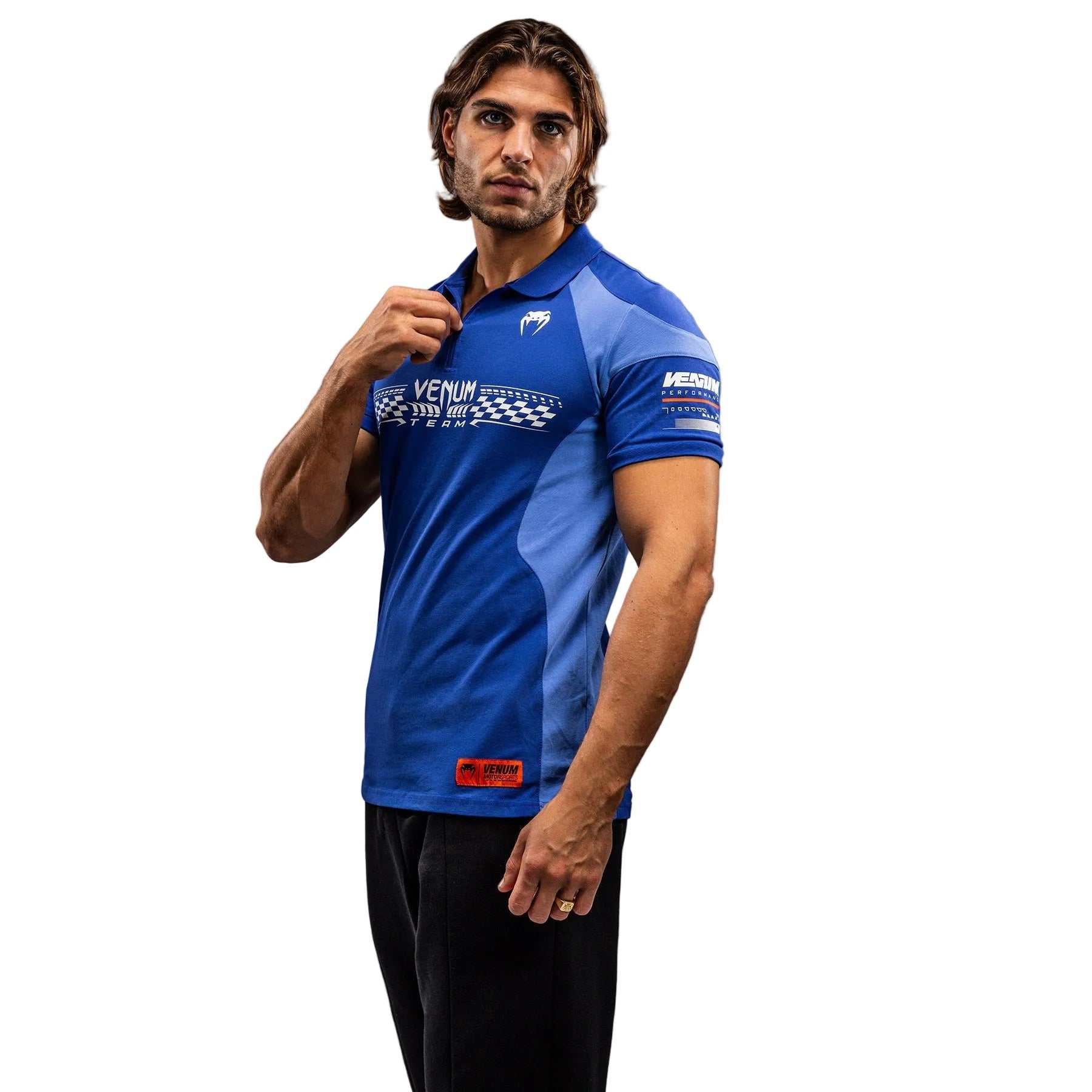 Polo Venum Motorsport bleu royal en coton 100% avec col zippé et patchs motorsport.